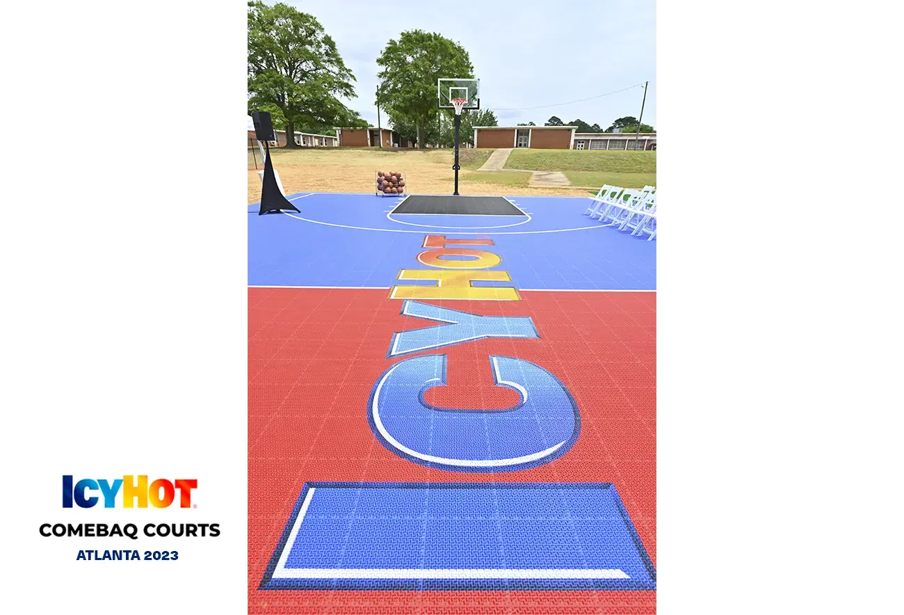 An image of the newly renovated basketball court in Atlanta, featuring the vibrant red and blue Icy Hot logo on the floor. In the lower-left corner of the image, a label displays the Icy Hot Comebaq Courts logo, along with the event's year (2023) and location (Atlanta).