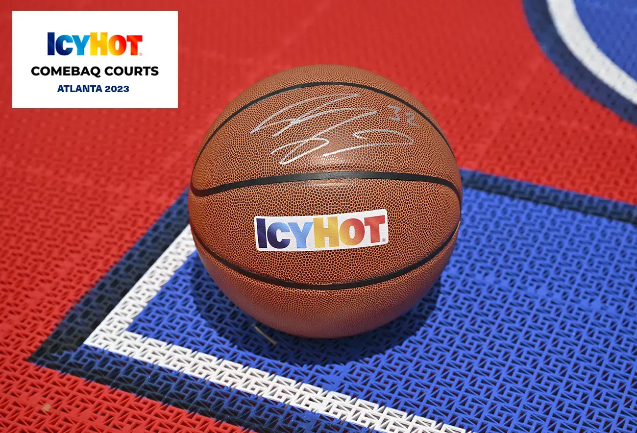 A basketball ball signed by Shaquille O'Neal adorned with the iconic Icy Hot logo. The upper-left corner of the image showcases a label featuring the Icy Hot Comebaq Courts logo, along with the event's year (2023) and location (Atlanta).