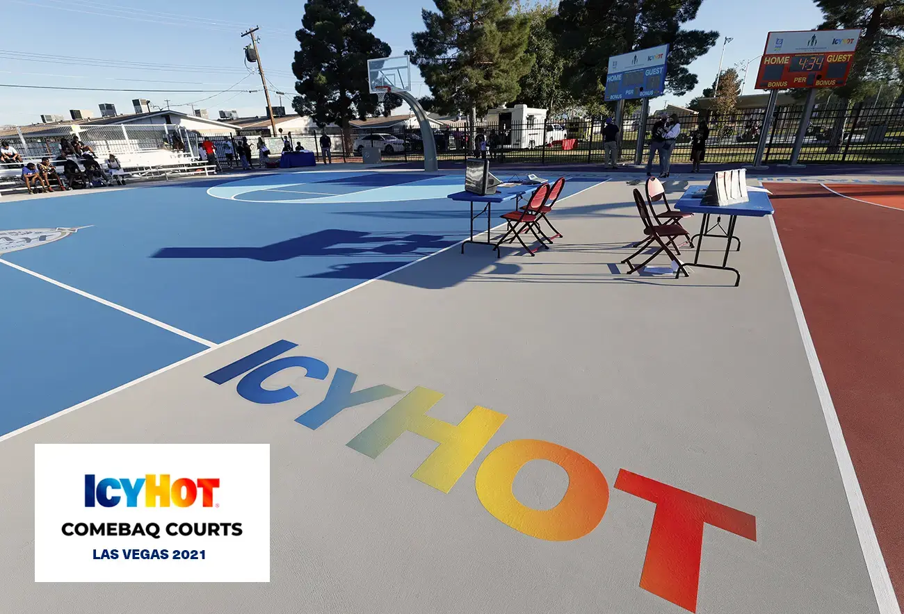A captivating view of the newly renovated basketball court in Las Vegas showcasing the dynamic Icy Hot logo prominently displayed on the floor.  The lower-left corner of the image features a label displaying the Icy Hot Comebaq Courts logo, along with the event's year (2021) and location (Las Vegas).