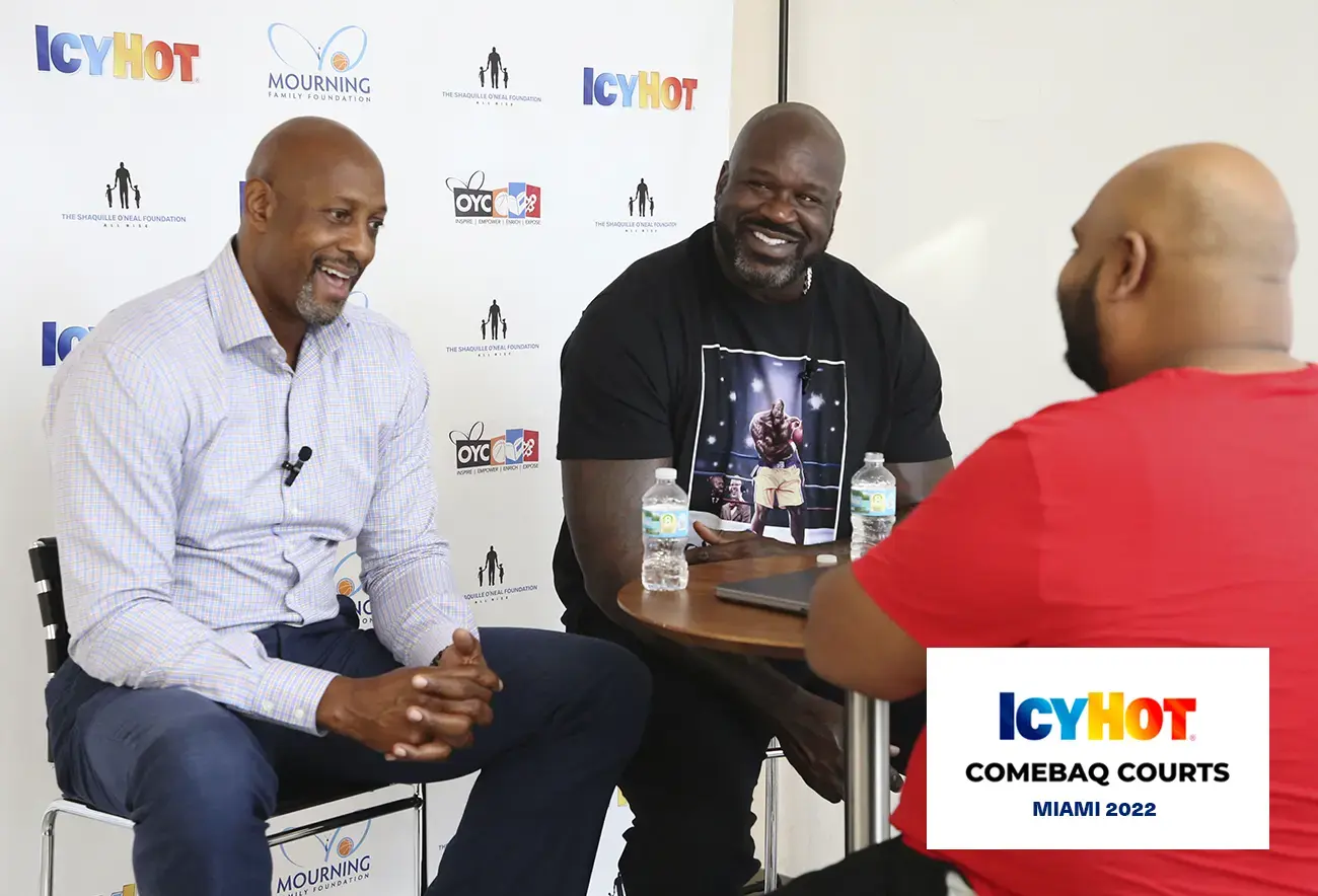 Shaquille O'Neal and Alonzo Mourning at a press event on the newly renovated basketball court at Overtown Youth Center (OYC) in Miami, Florida. In the lower-right corner of the image, a label displays the Icy Hot Comebaq Courts logo, along with the event's year (2022) and location (Miami).