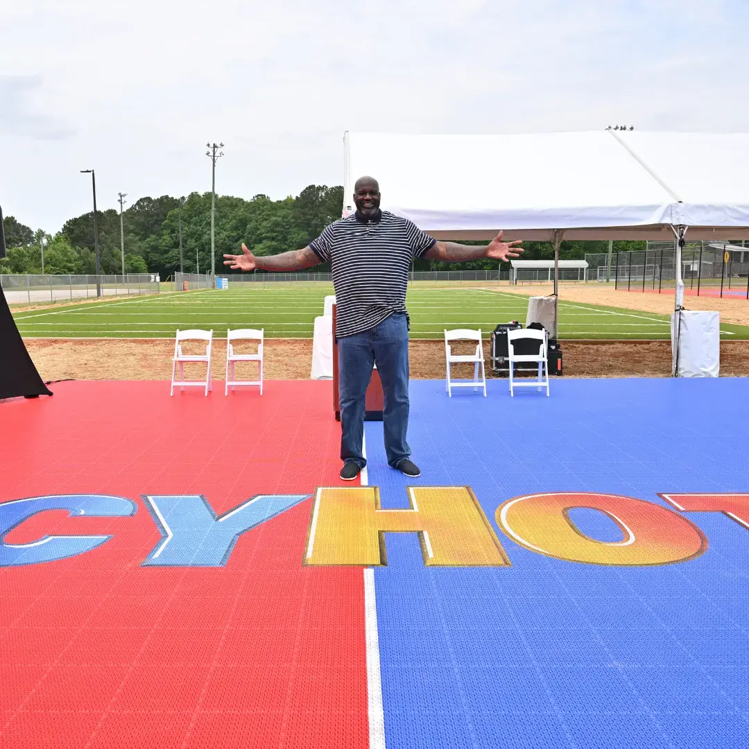 Shaquille O'Neal standing at the center of the newly unveiled Comebaq Court in Atlanta, with the prominent Icy Hot logo displayed on the court.