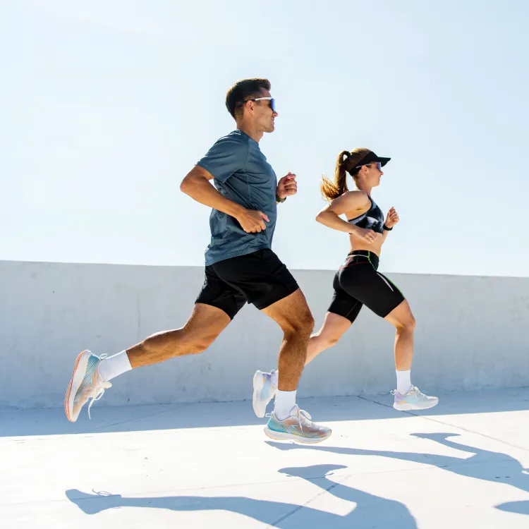 A man and a woman running outdoors.